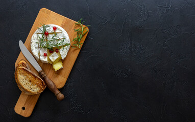 Oven baked Camembert cheese with honey, figs, and fresh bread