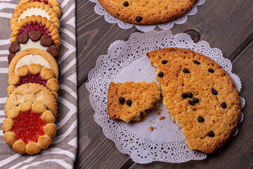 oatmeal and shortbread cookies with filling on the background of a wooden table