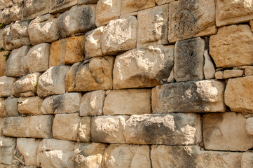 Big stones sandstone ancient dry masonry wall closeup as stone background