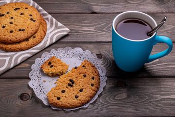 cookies with different fillings and a Cup of tea on a wooden table