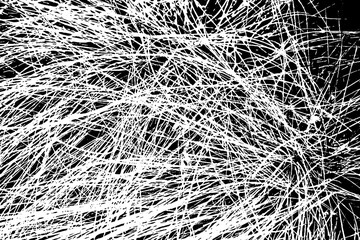 The grunge texture is black and white. Monochrome abstract background. Pattern of scratches, chips, and paint strokes. Black smudges, scuffing, wear and tear