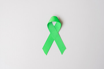 green Ribbon color on grey background for supporting people living and illness. Liver, Gallbladders...