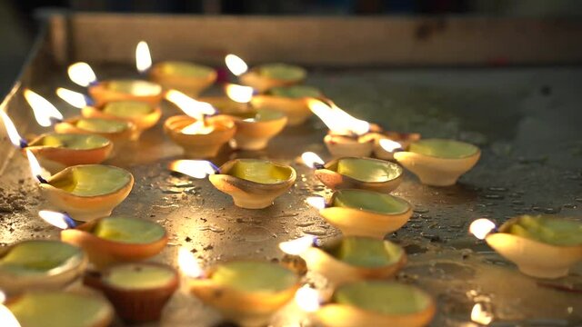 Multiple Oil lamps burning at a temple