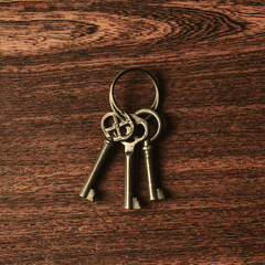 Old keys on a wooden background.
