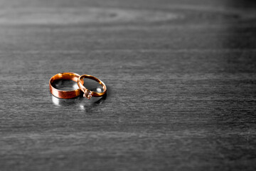 Gold wedding rings on a black white background.Wedding attributes. Wedding ceremony