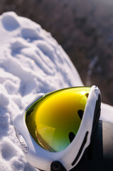 Ski goggles and helmet in the snow