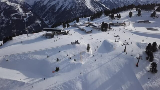 Aerial view of skiers on ski slopes in Penken area, Mayrhofen ski resort, Tyrol, Austria.