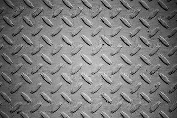 evocative image of black and white texture of iron surface with non-slip reliefs