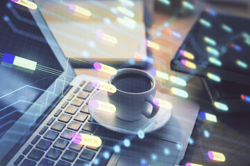 Double exposure of desktop computer and technology theme hologram. Concept of software development.