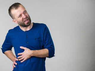 Man having stomach or ribs pain ache.