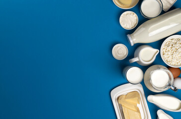 Collection of dairy products on blue background, top view - obrazy, fototapety, plakaty