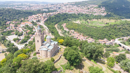 Fototapeta na wymiar Old Balkan fortress on Bulgaria, world heritage in Veliko Tarnovo. Historical structure medieval castle on a hill. Drone aerial view of sightseeing monument landmark. Cultural Stronghold