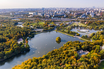 a panoramic view of the historic lake and park complex with roads and bridges filmed from a drone