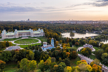 a panoramic view of the ancient palace and a large green park complex with a lake filmed from a drone