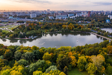 a panoramic view of the historic lake and park complex with roads and bridges filmed from a drone