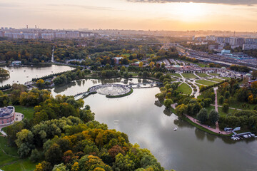 a panoramic view of the historic lake and park complex with roads and bridges filmed from a drone