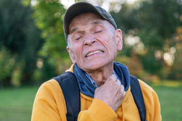 old man with pain on face hold and touch your neck after mosquito bite - obrazy, fototapety, plakaty