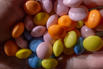 Small colorful round candys in heand