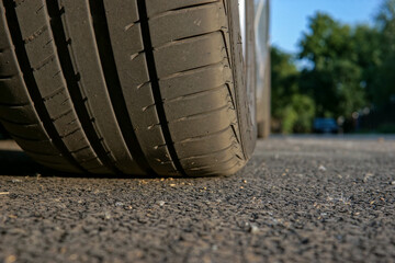 Car wheel on the asphalt, close-up.  