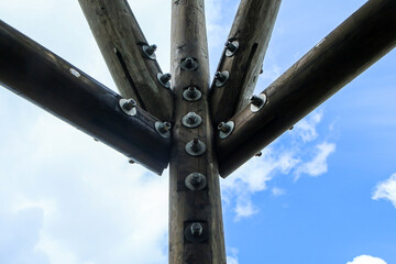 The detail of the joint on the wooden tower with many screws. 