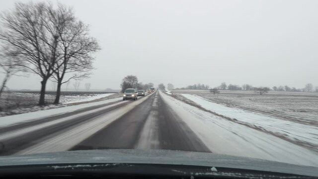 Winter driving on snowy road surface, oncoming traffic