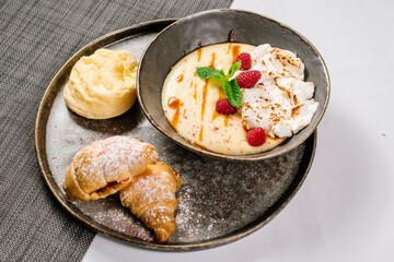 breakfast of porridge with cream, raspberry and honey