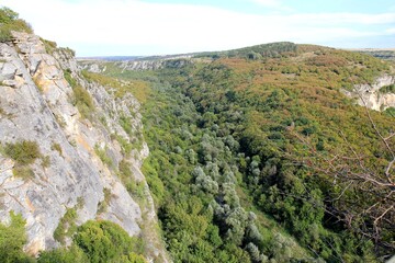 Fototapeta premium Rocks in the vicinity of the Orlova Chuka cave and the Cherni Lom river in Bulgaria in autumn