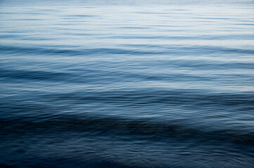 ocean with light waves in bright blue as conceptual background