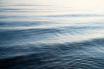 ocean with light waves in bright blue as conceptual background