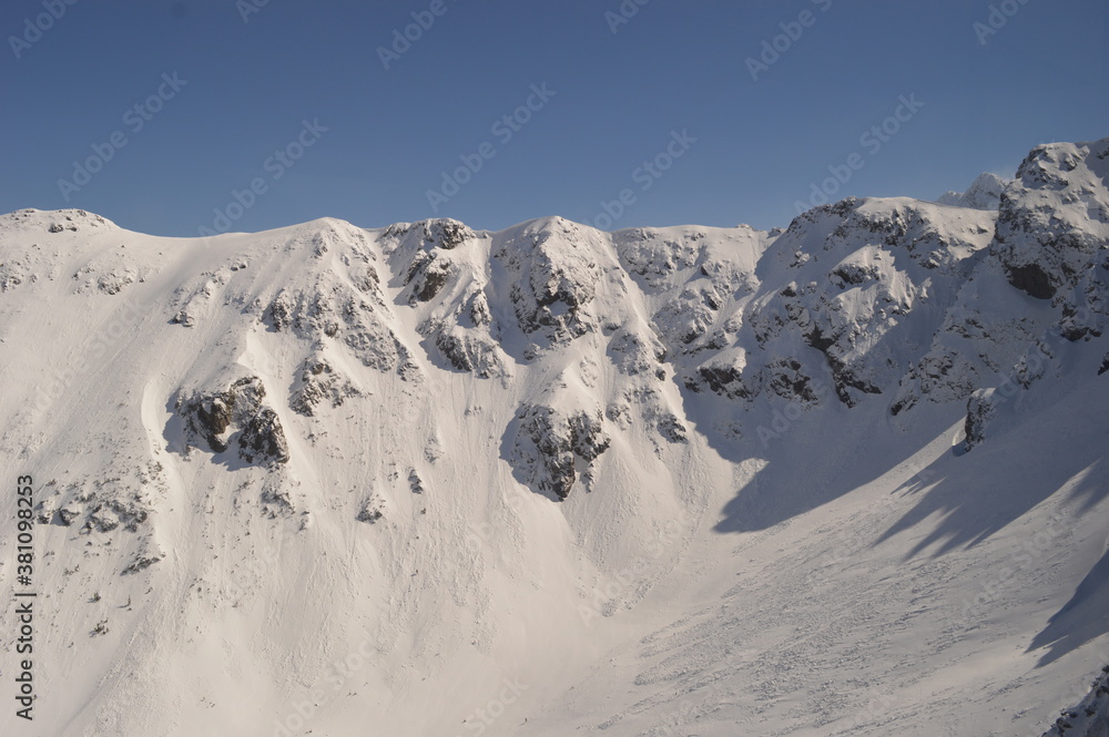 Wall mural skiing and snowboarding in the jasna and zakopane ski resorts between poland and slovakia in the tat