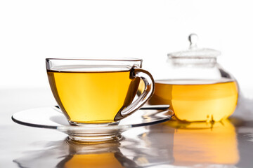 a cup of freshly brewed hot tea in transparent glass on the table
