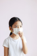 Portrait of Asian little girl wears a sanitary mask and cough