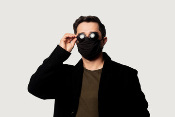Style guy in black coat, face mask and sunglasses