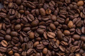roasted aromatic coffee beans closeup sprinkled on a table