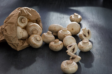 Mushrooms champignons royal scattered on a wooden background