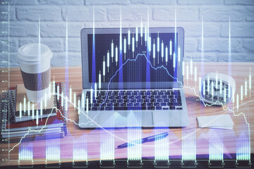 Double exposure of graph and financial info and work space with computer background. Concept of...
