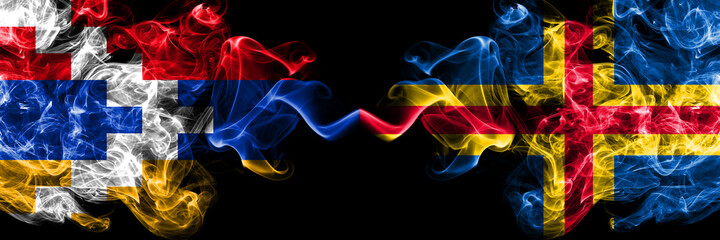 Nagorno-Karabakh, Artsakh vs Aland smoky mystic flags placed side by side. Thick colored silky abstract smoke flags