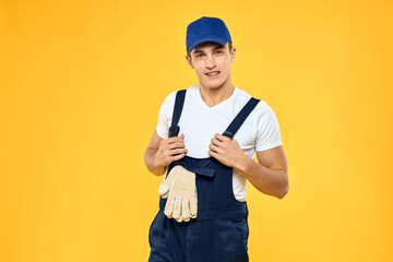 Man in working uniform emotions rendering service delivery service yellow background