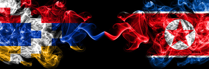 Nagorno-Karabakh, Artsakh vs North Korea, Korean smoky mystic flags placed side by side. Thick colored silky abstract smoke flags