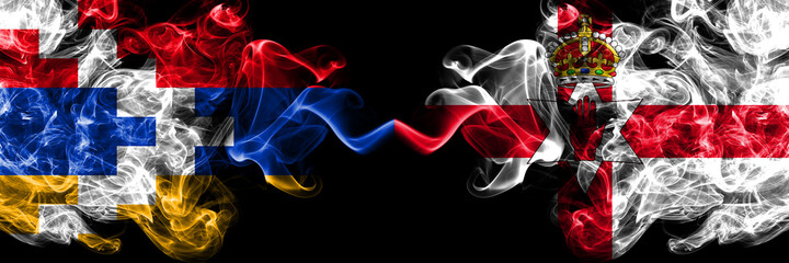 Nagorno-Karabakh, Artsakh vs Northern Ireland smoky mystic flags placed side by side. Thick colored silky abstract smoke flags