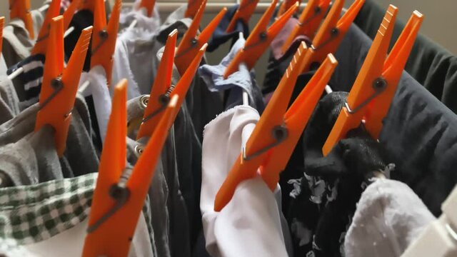 laundry hanging out to dry on a clothesline with orange clothespins. Housework and cleaning clothes.