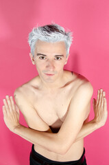 Young attractive guy. Pink background.