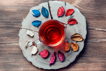 Autumn concept, tea relaxing warming healing aromatic of dried flowers creative flat layout in fall foliage colors red yellow orange gold tone