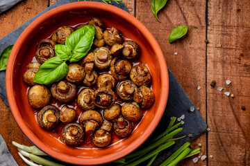 Baked champignons with spices, top view. Vegetarian food
