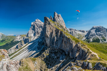 Seceda peak with a paraglider, Santa Cristina Val Gardena, Dolomites, South Tyrol, Italy