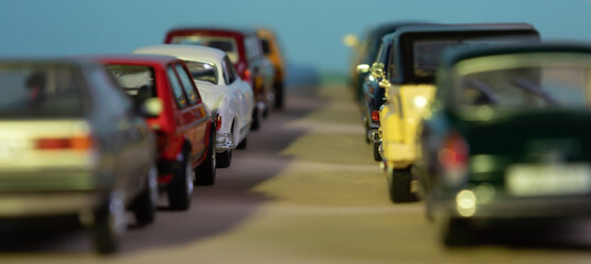 Looking through two rows of toy cars, symbol for start traffic and traffic jam, focus on one car