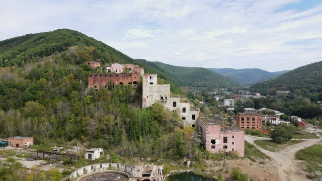 View from above. Khrustalnensky mining and processing plant. The camera pans over the destroyed abandoned buildings of a mining factory in Russia