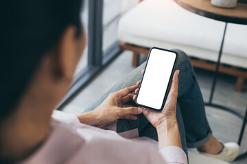 cell phone mockup blank white screen.woman hand holding texting using mobile on desk at coffee shop.background empty space for advertise.work people contact marketing business,technology