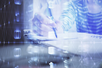 Double exposure of hands making notes with digital coding icons. Computer learning concept.