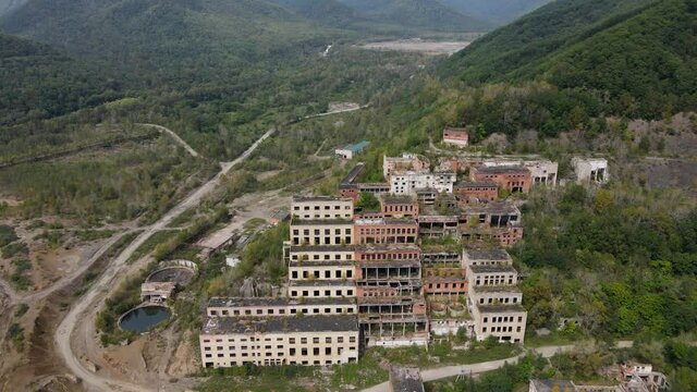 View from above. Khrustalnensky mining and processing plant. The camera pans over the destroyed abandoned buildings of a mining factory in Russia